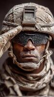 Soldier in desert gear salutes with dusty uniform under harsh sunlight in a sandy environment photo