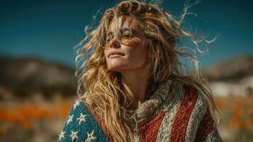 Woman in sunglasses wearing a colorful sweater with stars stands outdoors surrounded by vibrant orange flowers photo