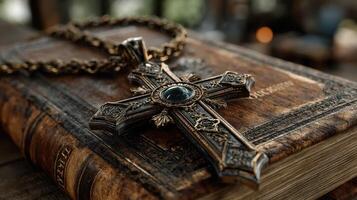 Intricate cross and antique book resting on a wooden table in a cozy, dimly lit setting photo