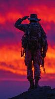 Soldier salutes against a breathtaking sunset backdrop highlighting courage and dedication in military service photo