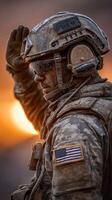 Soldier saluting at sunrise in a rugged environment showcasing commitment and resilience photo