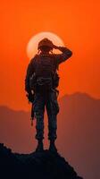 Soldier saluting at sunset with mountains in the background during golden hour photo