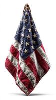 Worn American flag displayed against a neutral background highlighting its faded colors and fabric texture photo
