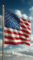 United States flag waving under a bright sky with fluffy clouds during a sunny day photo