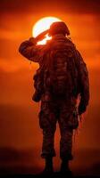 Soldier saluting the setting sun in a dramatic twilight backdrop photo