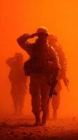 Soldiers saluting in a dusty environment during a military operation at sunset photo