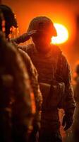 Soldiers salute as the sun sets, creating a dramatic backdrop during training exercises at dusk photo