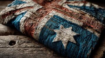 Australian flag displayed on weathered wood emphasizing cultural heritage and national pride at a rustic location photo