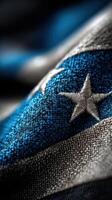 Close-up of a textured flag design highlighting blue and silver colors with intricate stitching details photo