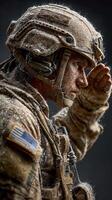 Soldier in tactical gear salutes amid snow, reflecting determination and strength in a cold environment photo