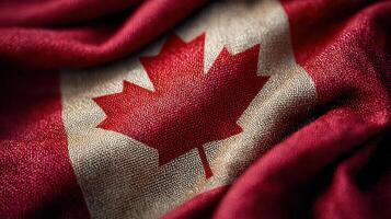 Waving Canadian flag with iconic maple leaf design on textured fabric background photo