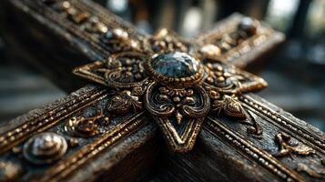 Intricate design of a vintage cross adorned with ornate details and a central gemstone in natural light photo