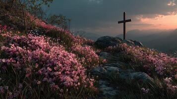 Peaceful sunset over a cross surrounded by blooming pink flowers on a hillside photo
