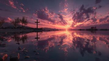 Stunning sunset over calm water with cross silhouette against beautiful clouds in serene landscape photo