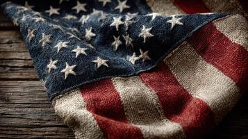 Vintage American flag draped over rustic wooden surface with detailed texture and color contrasts photo