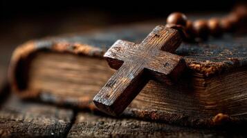 A close-up view of a wooden cross and an old, worn book on a rustic wooden surface during a quiet moments of reflection photo