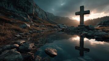 Cross reflection in tranquil waters at sunset amidst rugged mountains and stormy skies photo