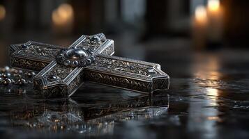 Intricate silver cross resting on a polished surface with soft candlelight in the background during a serene evening setting photo
