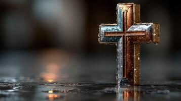 Cross with water droplets reflecting light in a serene setting creating a calm spiritual atmosphere photo