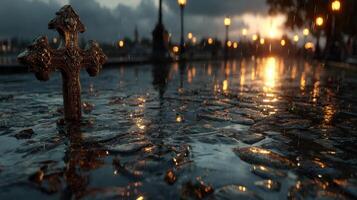 Rain-soaked cross at sunset amidst puddles and street lights photo
