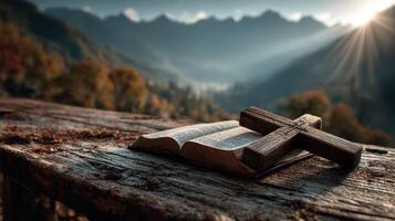 Natural landscape with an open Bible and a wooden cross at sunset photo
