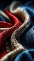 Colorful fabric textures create an abstract art piece with vibrant red, blue, and neutral tones in soft folds photo