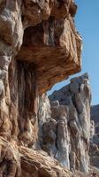 Rock formations rise dramatically under clear blue sky showcasing natural beauty and geological wonders in a serene outdoor setting photo