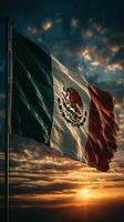 Waving Mexican flag against a dramatic sunset sky with clouds in the background photo