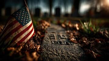 American flag marks a grave in a quiet cemetery during autumn at sunset photo