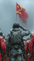 Soldiers salute under a flag during a military event in a challenging weather setting photo