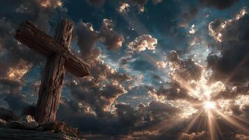 Wooden cross stands tall beneath dramatic clouds and rays of sunlight at twilight photo