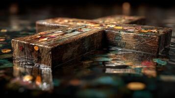 Wooden cross floating in water surrounded by coins under soft ambient light photo
