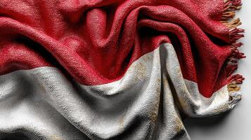 Close-up view of a textured Indonesian flag displaying red and white colors with soft fringes creating a cozy atmosphere photo