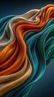 Colorful fabric waves displaying vibrant hues of orange, white, and green against a dark backdrop in a close-up view photo