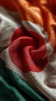 Textile featuring the national flag of Japan in vibrant colors, folded artistically to showcase texture and detail photo