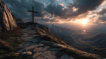 Scenic sunset view with a cross on a rocky hilltop overlooking a valley and mountains photo