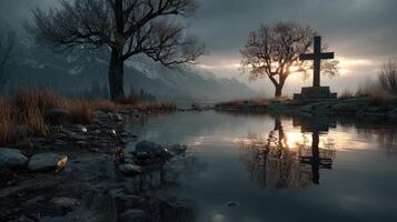 Serene landscape with cross by the water at sunset in a mountainous region photo