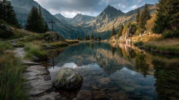 Mountain lake reflects stunning peaks during early morning light in serene nature setting photo