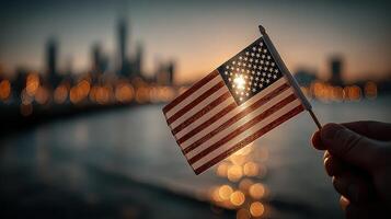 Waving a small American flag at sunset with a city skyline in the background photo