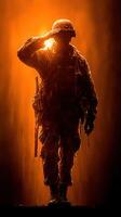 Soldier saluting against a dramatic orange background during dawn in a moment of reflection photo