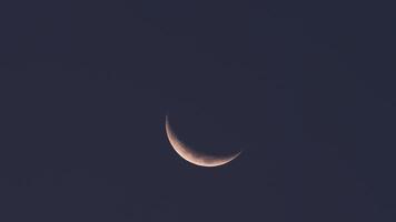 Glowing crescent moon shining in a deep night sky. Mesmerizing celestial view ideal for concepts of space, serenity, and nighttime wonder. video