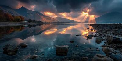 Majestic sunset over a tranquil lake reflecting mountains and colorful clouds in autumn photo