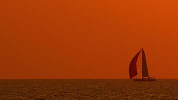 Sailing yacht against the backdrop of a beautiful golden sunset video
