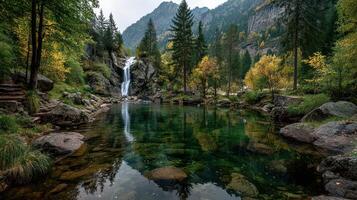 Waterfall cascades into a tranquil pool surrounded by vibrant autumn foliage in a mountainous landscape photo
