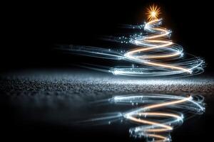 Decorative Christmas tree created with light trails reflecting on a dark surface during the holiday season photo