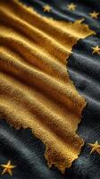 Close-up of a textured flag with intricate details showcasing gold and dark patterns representing unity photo