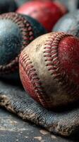 Vintage baseballs resting on a worn cloth with uneven stitching and faded colors in a natural light setting photo