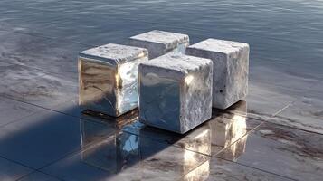 Reflective cubes resting on a glossy surface beside water at dusk photo