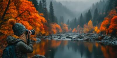 Autumn landscape with a photographer capturing vibrant fall colors by the water in a serene mountainous area photo