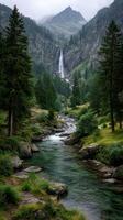 Scenic mountain waterfall cascading into a tranquil river surrounded by lush evergreen trees in a misty atmosphere photo